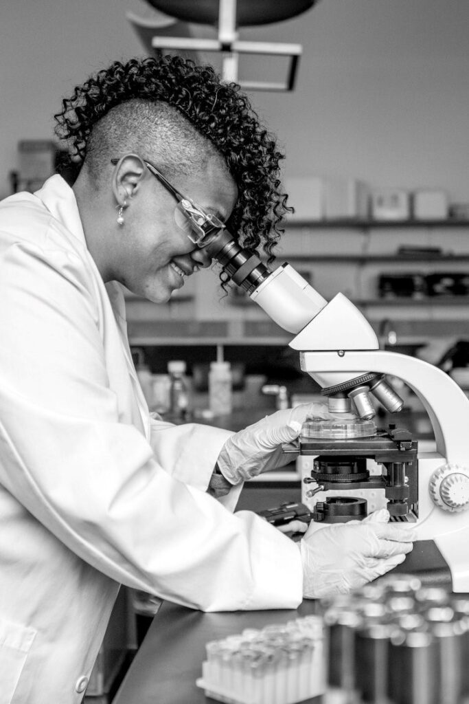 Dr. Maisha Gray Diggs looking into a microscope